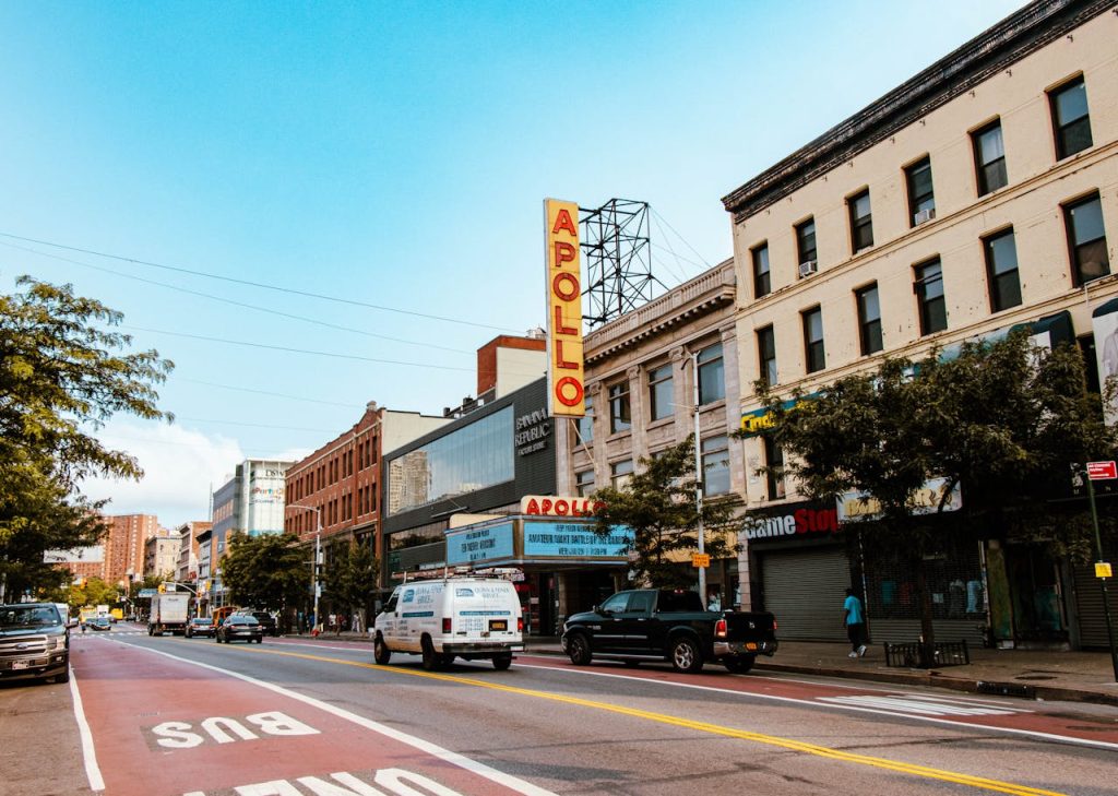 apollo-theater-in-new-york-17640362 Street view of Apollo Theater in New York City, showcasing urban life and architecture.